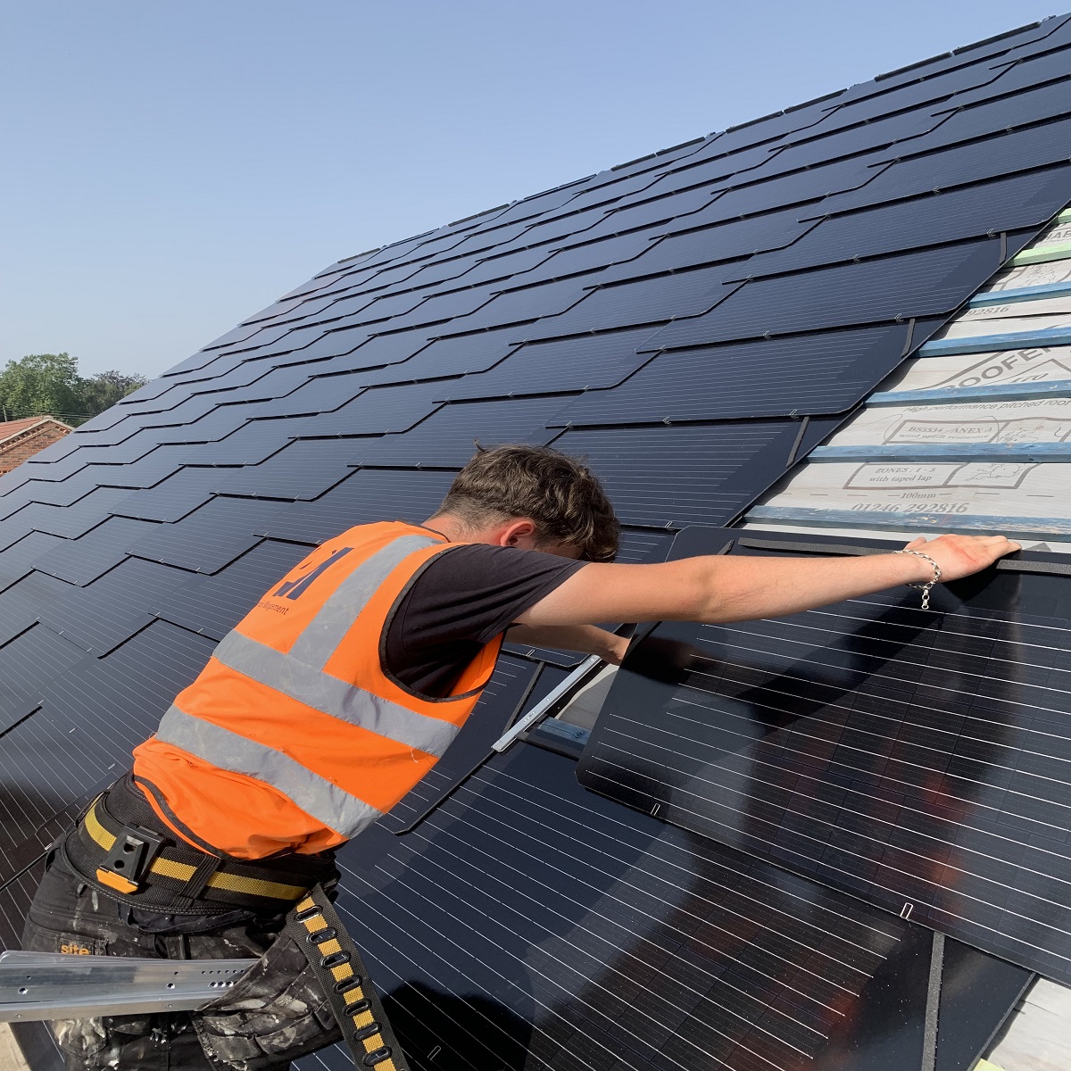 man installing solar roof tiles